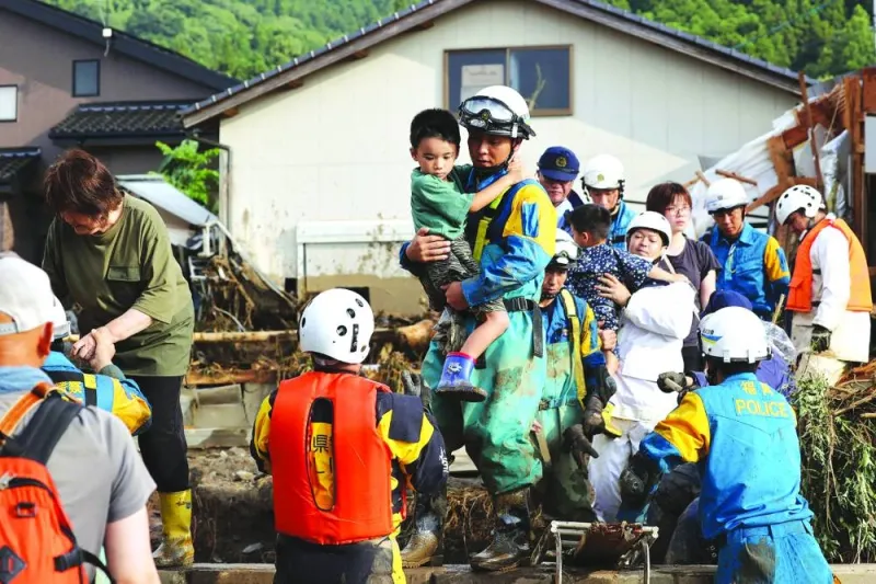 
Residents are rescued following a flood in their street in Tanushimarumachi in the city of Kurume, Fukuoka prefecture, after heavy rains hit wide areas of Kyushu island. 