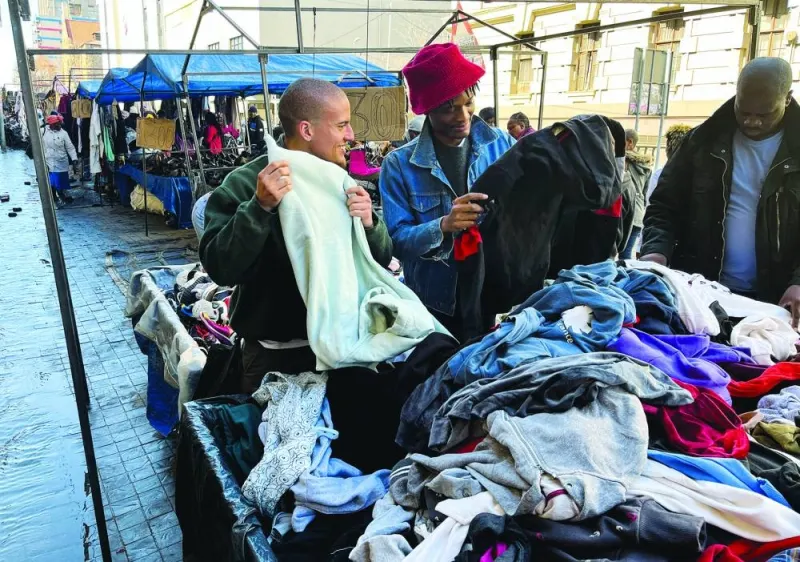 
South African aspiring designers Khumo Morojele and Klein Muis source for second-hand clothing imported from the West and sold in bales in markets known as Dunusa, in Johannesburg. 