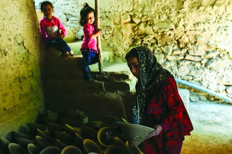 
A child carries dried clay bowls at a traditionally run factory in Istalif district in northwest of Kabul province. Afghanistan has a 
centuries-old tradition of pottery across the country, but Istalif’s reputation for craftsmanship and quality stands out. 
