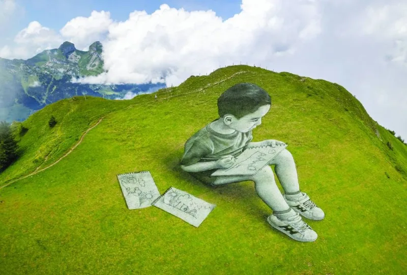 
A land art painting depicting a child drawing by Swiss-French artist SAYPE is seen at the Chamossiare in Villars-sur-Ollon, Switzerland. 