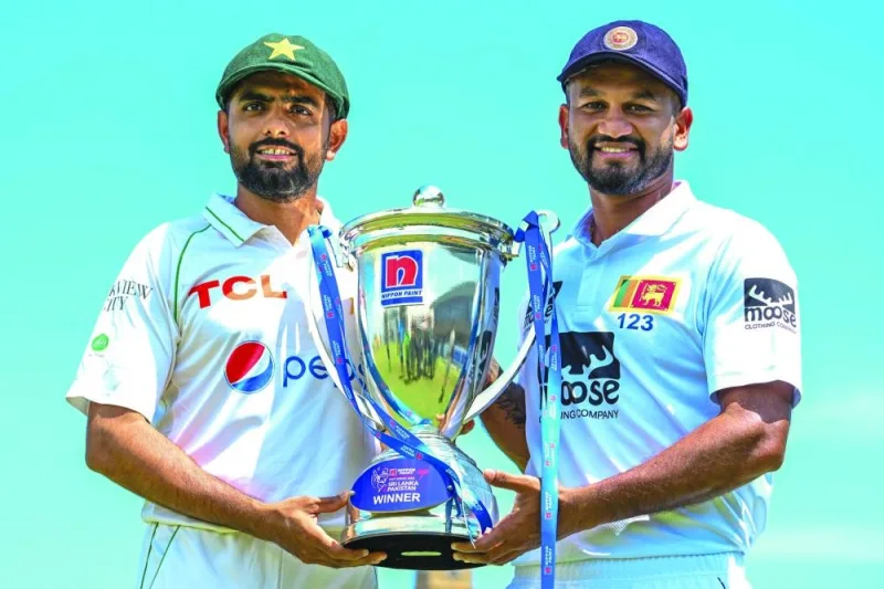 Sri Lanka’s captain Dimuth Karunaratne (right) and Pakistan’s captain Babar Azam pose with the Test trophy at the Galle International Cricket Stadium in Galle ahead of their two-Test series. (AFP)