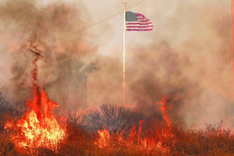 
The United States national flag is seen surrounded by flames during the Rabbit fire in Moreno Valley in Riverside County, California. 
