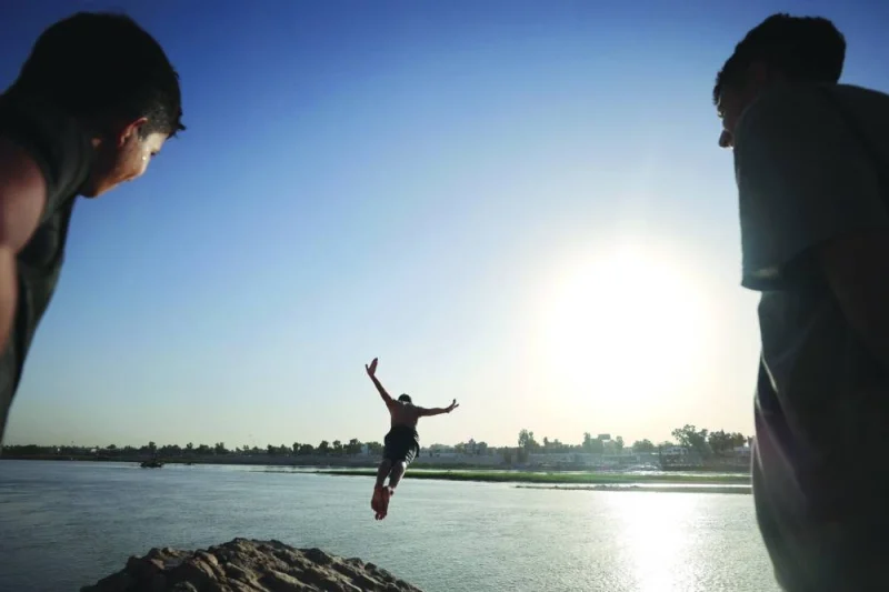 An Iraqi dives into the waters of the Tigris river in Baghdad, as temperatures soared past 45 degrees Celsius.