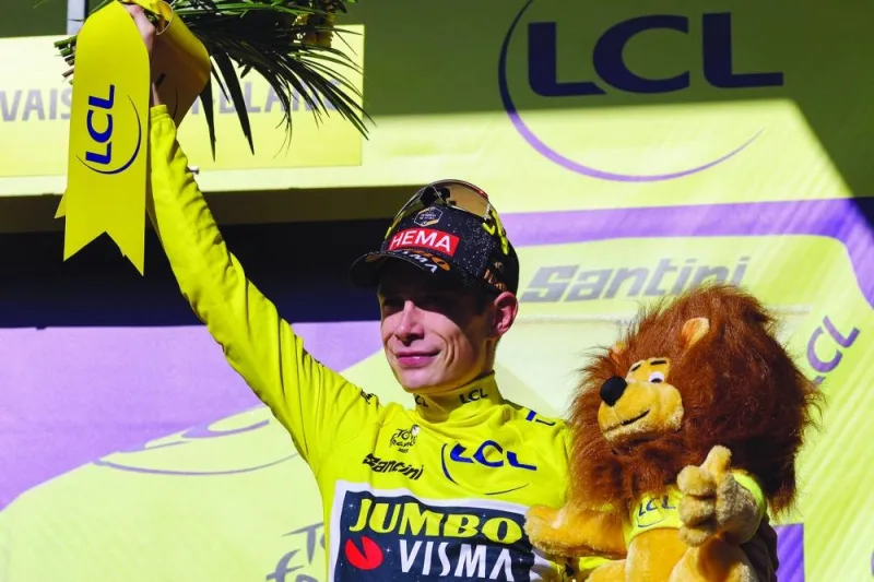 Jumbo-Visma’s Danish rider Jonas Vingegaard celebrates on the podium with the overall leader’s yellow jersey after the 15th stage of the 110th edition of the Tour de France at Saint-Gervais Mont-Blanc in the French Alps yesterday. (AFP)