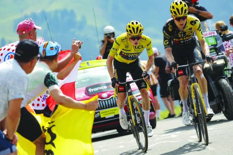 Jumbo-Visma’s Danish rider Jonas Vingegaard, wearing the overall leader’s yellow jersey (left), and Jumbo-Visma’s Dutch rider Wilco Kelderman cycle during the 17th stage of the 110th edition of the Tour de France in the French Alps, on Wednesday. (AFP)