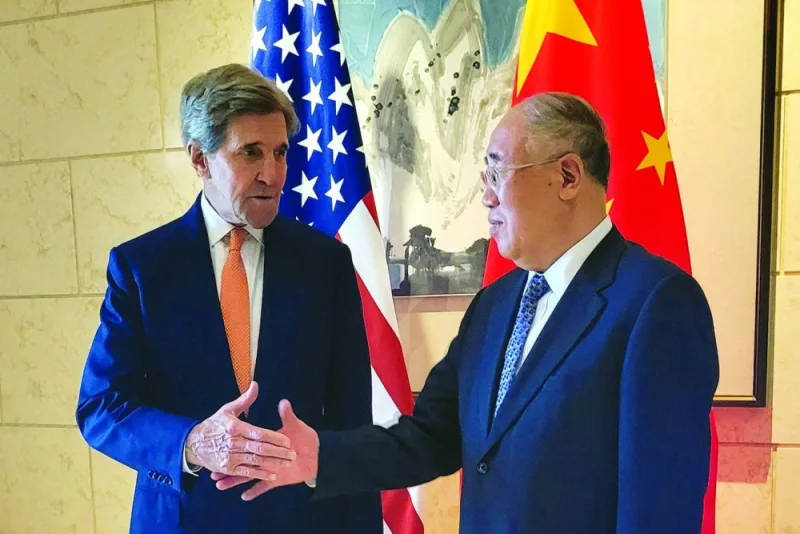 
US Special Presidential Envoy for Climate John Kerry (left) shakes hands with his Chinese counterpart Xie Zhenhua before a meeting in Beijing last Monday. (Reuters) 