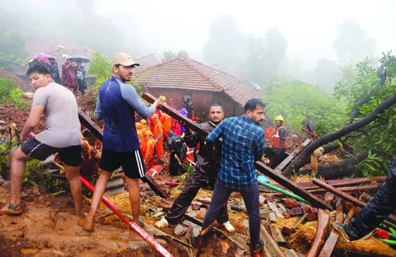 Rescue team members clear the debris as they search for survivors after a landslide following heavy rains in Raigad district in Maharashtra, India, on Thursday.