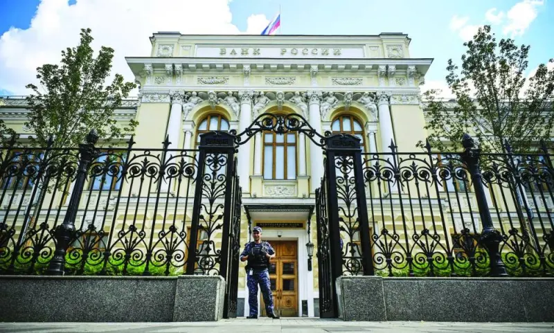 A police officer guards the entrance of the Russian central bank headquarters in downtown Moscow. Russia raised interest rates for the first time since emergency measures taken after the invasion of Ukraine almost 17 months ago, delivering a bigger increase than forecast by economists and signalling borrowing costs may rise higher still.