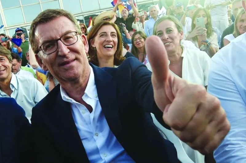 Popular Party (PP) leader Alberto Nunez Feijoo gives a thumbs-up during the campaign rally in A Coruna on Friday.