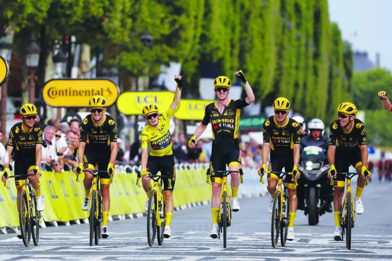 Jumbo-Visma’s Danish rider Jonas Vingegaard, wearing the overall leader’s yellow jersey, celebrates with teammates as he crosses the finish line during the 21st and final stage of the 110th edition of the Tour de France cycling race, covering a distance of 115kms between Saint-Quentin-en-Yvelines and the Champs-Elysees in Paris, on Sunday. (AFP)