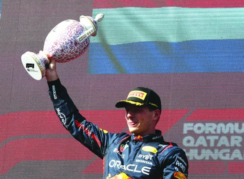 Red Bull’s Max Verstappen celebrates on the podium with a trophy after winning the Hungarian Grand Prix on Sunday. (Reuters)