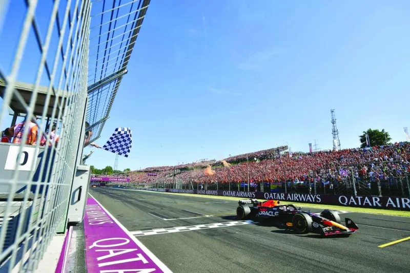 Red Bull Racing’s Dutch driver Max Verstappen is greeted by the checkered flag as he wins the Formula One Hungarian Grand Prix at the Hungaroring race track in Mogyorod near Budapest on Sunday. (AFP)