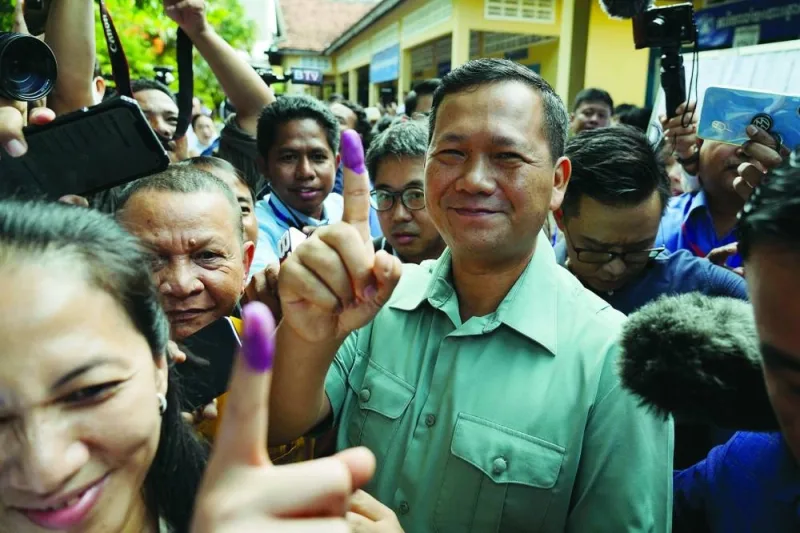 Hun Manet, commander of the Royal Cambodian Army and eldest son of Prime Minister Hun Sen, shows his finger after he casts his vote at a polling station in Phnom Penh on Sunday.
