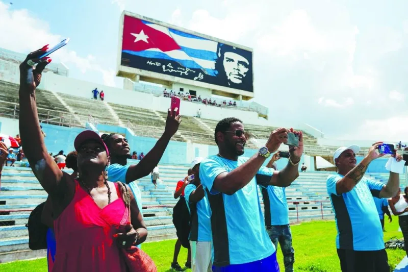 
Cuba’s high jump legend Javier Sotomayor (centre) takes pictures during a sports event in Havana, Cuba. (Reuters) 