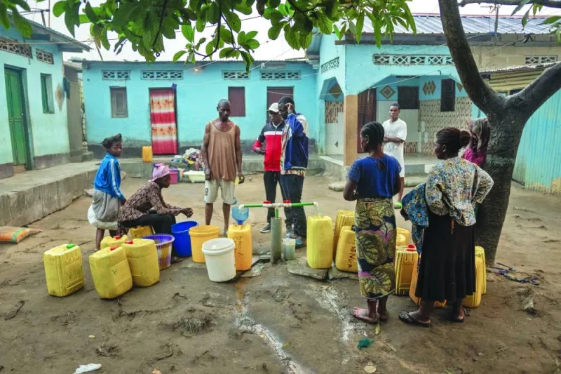 
People gather around a communal well in Selembao., a poor neighbourhood with very little water or electricity provision on the outskirts of Kinshasa. 