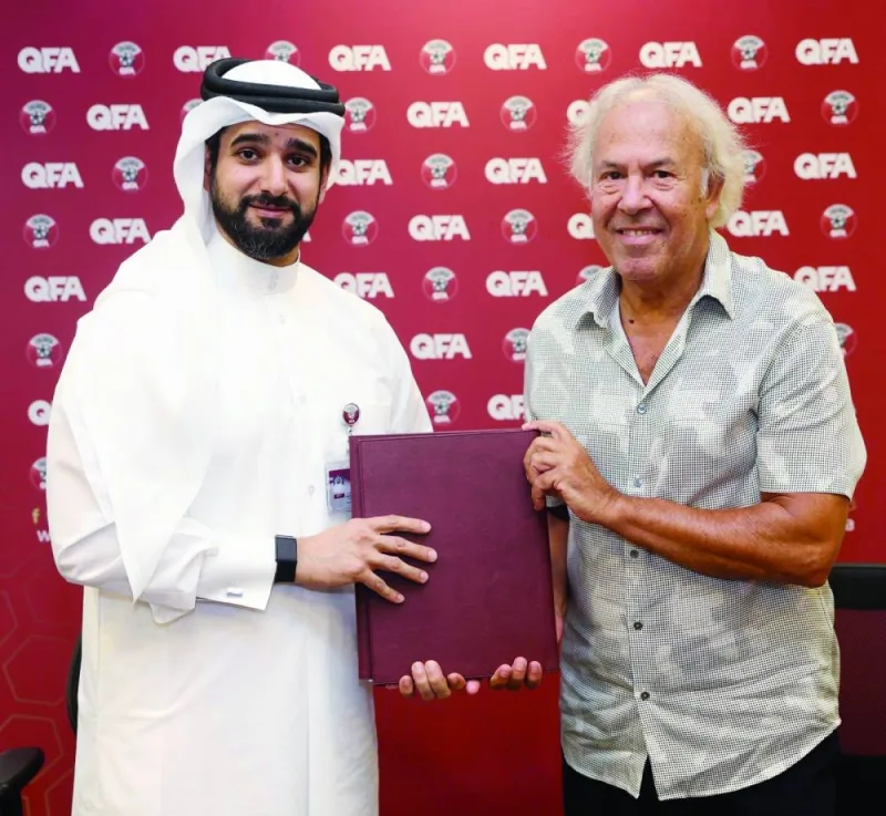 Qatar&#039;s under-23 new head coach Ilidio Vale poses with Qatar Football Association General Secretary Mansoor al-Ansari after signing the contract yesterday. 
