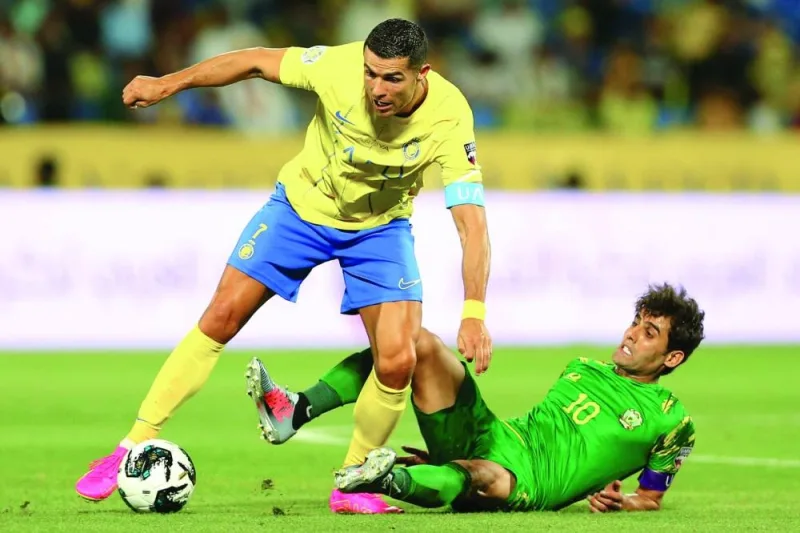 Al Nassr’s Cristiano Ronaldo (left) vies for the ball with Al Shorta’s Alaa al-Azzawi during the King Salman Club Cup semi-final at Prince Sultan bin Abdul Aziz Stadium in Abha, Saudi Arabia, on Wednesday.  (AFP)