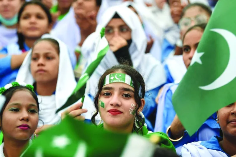 
Students wave Pakistan’s national flags in Karachi. (AFP) 