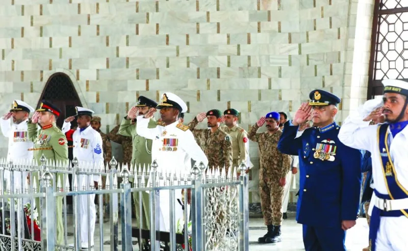 
Officers of the Armed Forces salute during wreath laying ceremony at the mausoleum of Pakistan’s founder, Muhammad Ali Jinnah, in Karachi. (Reuters) 