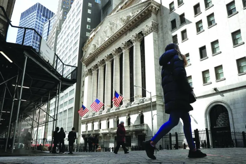 People are seen on Wall Street outside the New York Stock Exchange. Investors are the least pessimistic on stocks since February of last year, before the Federal Reserve began one of the most aggressive tightening cycles in decades, according to Bank of America Corp’s latest global survey of fund managers.