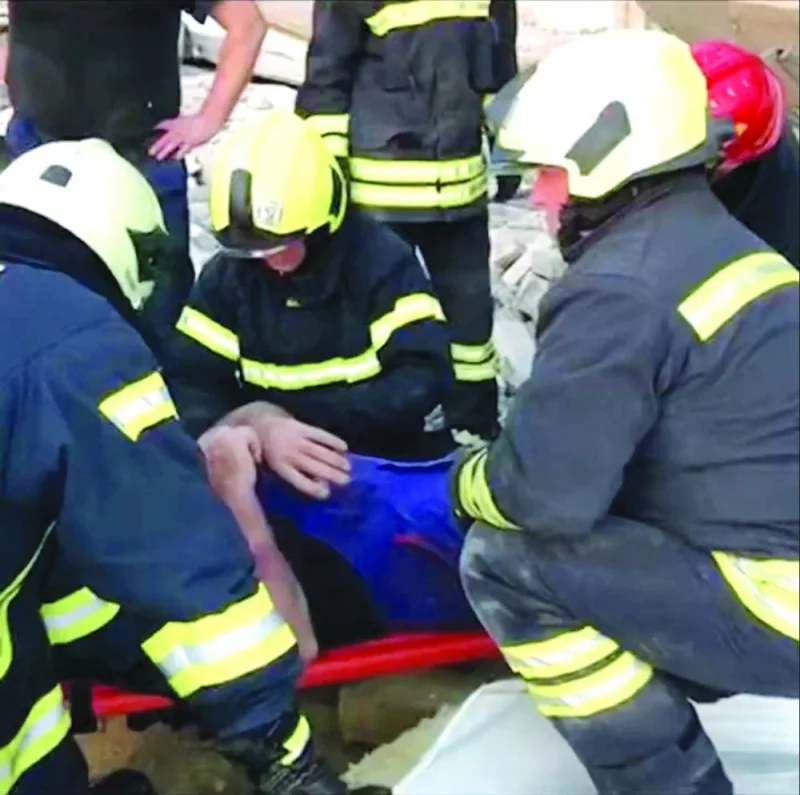 
Ukrainian rescuers assist a man on a stretcher after he was pulled out from under the rubble, following a Russian missile strike in Lutsk in this screengrab obtained from a social media video. (Reuters) 