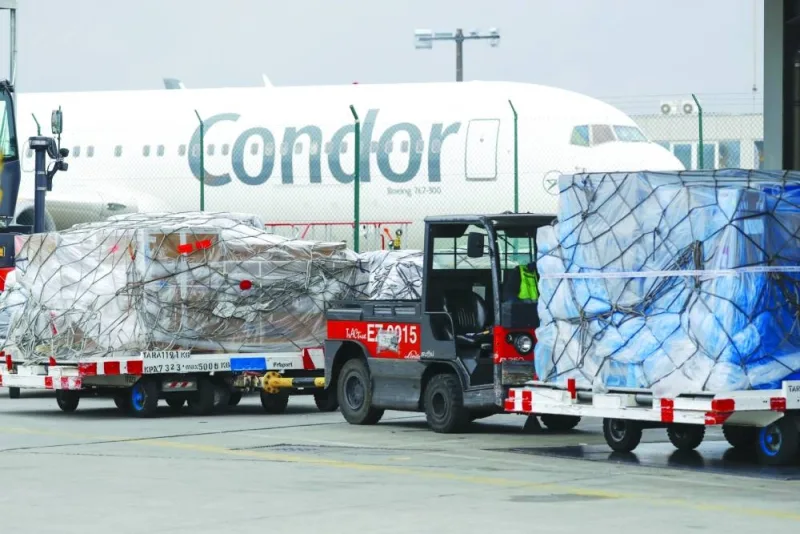 Sealed pallets of air cargo stand near a Condor aircraft at Frankfurt Airport (file). Global inflation and slackening manufacturing output have had a toll on air cargo demand, which slumped by 3.4% in June, although it was the lowest decline in one and a half years.