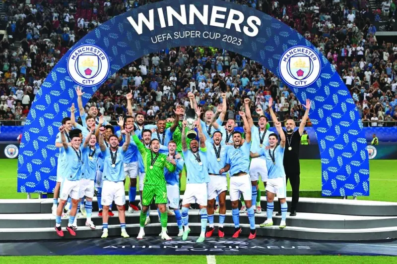 
Manchester City’s English defender Kyle Walker holds the trophy on the podium after winning the 2023 UEFA Super Cup match against Sevilla at the Georgios Karaiskakis Stadium in Piraeus. (AFP) 