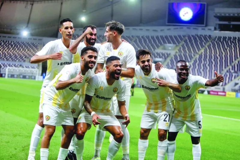 Qatar SC’s Bruno Tabata (second left) celebrates with teammates after scoring against Al Gharafa at the Khalifa International Stadium.