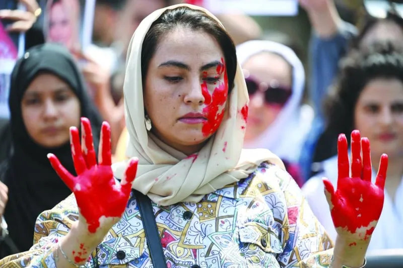 
This picture taken on Tuesday shows an Afghan national with her hands and face painted during a demonstration in Islamabad against the Taliban government, on the occasion of the second anniversary of the Taliban takeover of Afghanistan. 