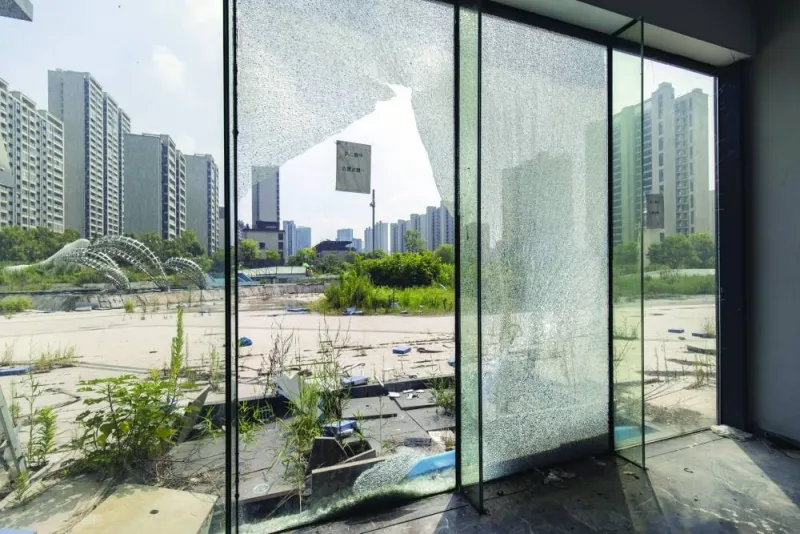 
Damaged glass windows at the deserted sales office for the Legend of Sea project, co-developed by Country Garden Holdings Co and Jiangsu Zhongnan Construction Industry Group Co, in Ningbo, China. Global stock managers are bracing for pain as China’s dramatic slowdown undermines the prospects for companies elsewhere that rely on the world’s second-largest economy. 