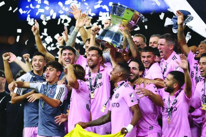 
Lionel Messi of Inter Miami hoist the trophy with his teammates after defeating the Nashville SC to win the Leagues Cup 2023 final at GEODIS Park in Nashville, Tennessee. Right: Messi poses with the awards for the best player and top scorer. (AFP) 