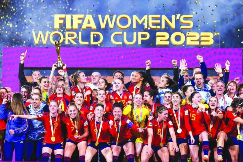 Spain’s players and officials celebrate with the trophy after winning the Women’s World Cup final against England in Sydney on Sunday. (AFP)