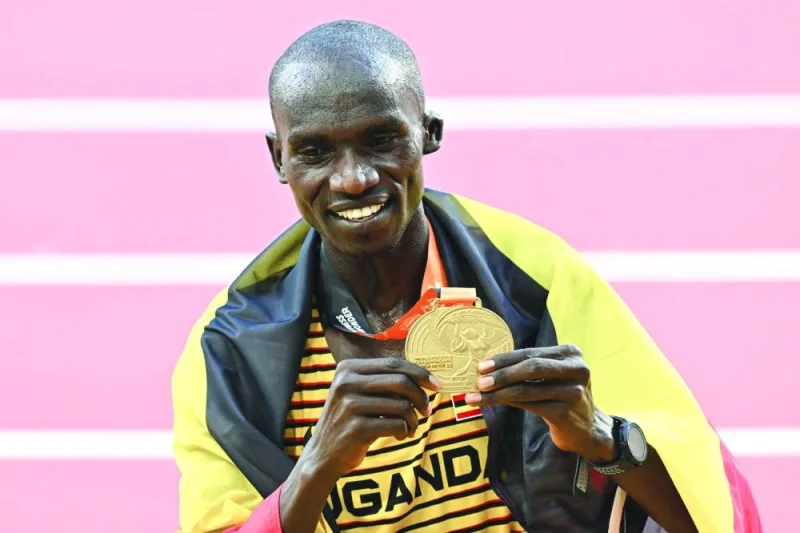 Uganda’s 10,000m gold medallist Joshua Cheptegei celebrates while draped in a national flag on Sunday. (AFP)