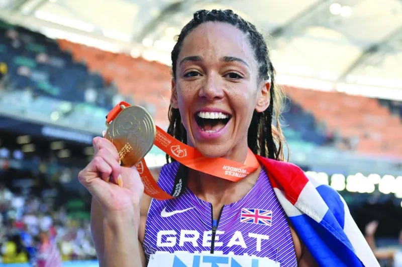 Britain’s Katarina Johnson-Thompson celebrates with her gold medal after winning the heptathlon event on Sunday. (AFP)