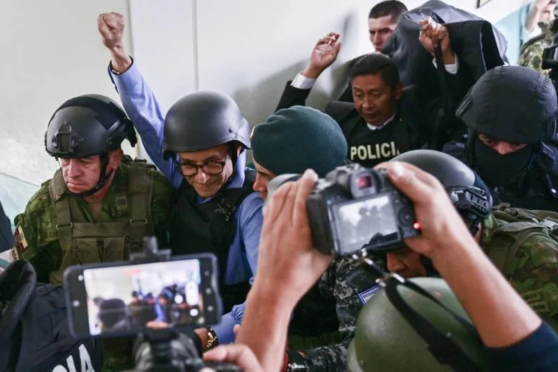 
Presidential candidate Christian Zurita gestures under heavy security at a polling station in Quito. 