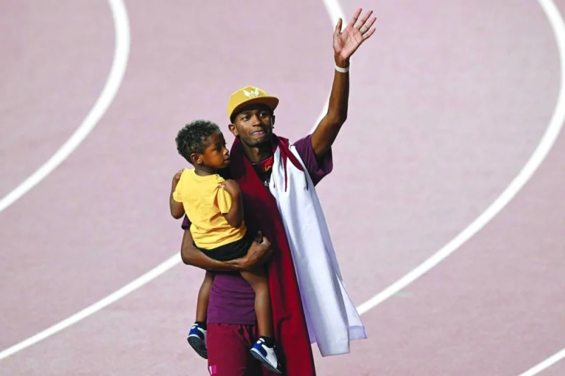 
Mutaz Barshim holds his son as he acknowledges the crowd after winning the bronze in Budapest. (AFP) 