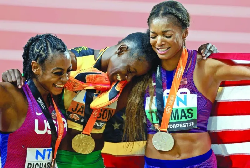Women’s 200m gold medallist Shericka Jackson (centre) celebrates after winning the final alongside silver medallist Gabrielle Thomas (right) and bronze medallist Sha’Carri Richardson in Budapest on Friday. (Reuters)