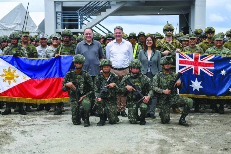 Australian Defence Minister Richard Marles (centre), Philippine Defence Secretary Gilberto Teodoro (left) and Australian ambassador to the Philippines Hae Kyong Yu (right) pose with Australian and Philippine soldiers after witnessing the joint exercise at a naval base in San Antonio town, Zambales province, on Friday.
