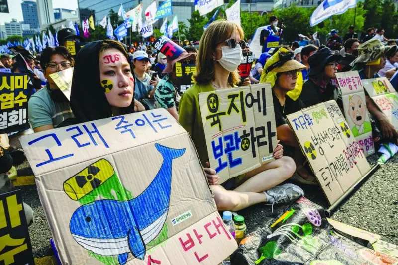 
Activists hold placards reading ‘We are against contaminated water that kills whales’ (left) and ‘Store it on land’ as they take part in a rally in Seoul against Japan’s discharge of treated wastewater from the crippled Fukushima nuclear power plant. 