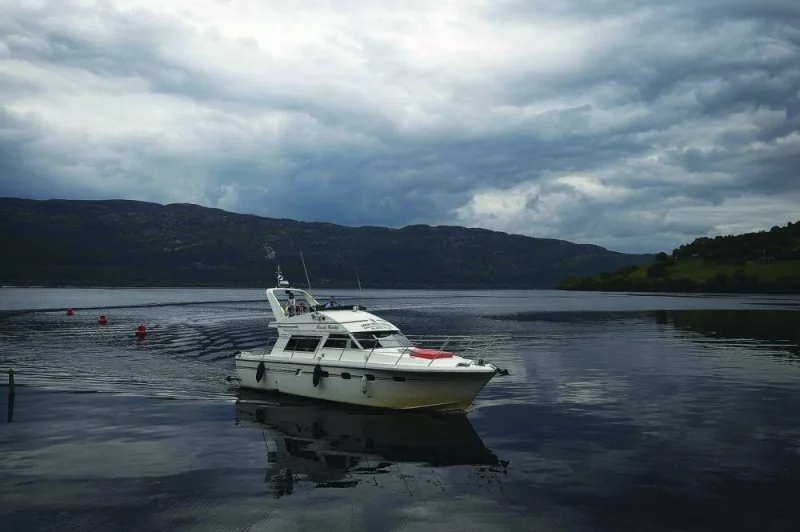 
Right: Tourists take a cruise aboard the ‘Nessie Hunter’ boat on Loch Ness. 