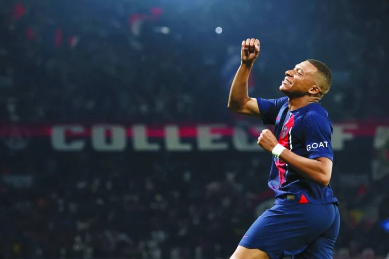 Paris Saint-Germain’s French forward Kylian Mbappe punches the air as he celebrates scoring during the Ligue 1 match against RC Lens at the Parc des Princes Stadium in Paris on Sunday. (AFP)