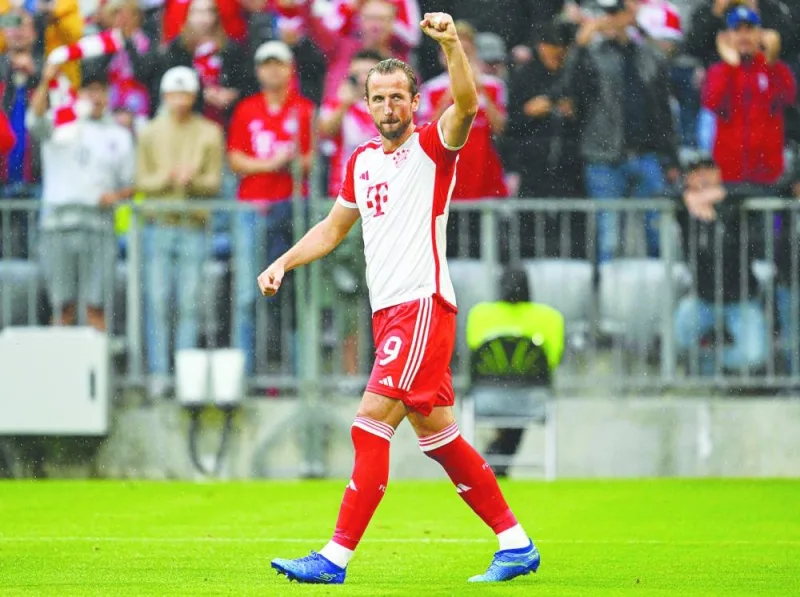 Bayern Munich’s Harry Kane celebrates after scoring against Augsburg on Sunday. (AFP)