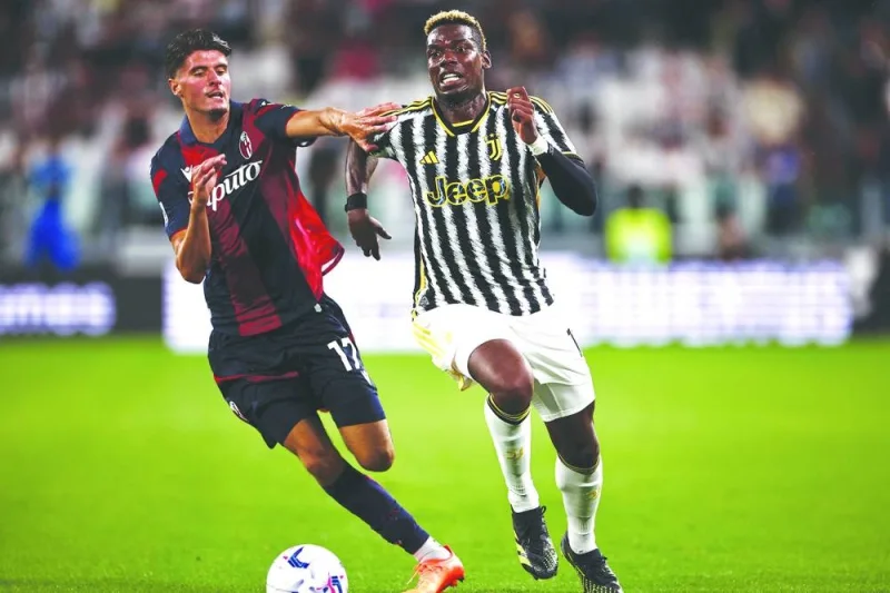 Bologna’s midfielder (17) Oussama El Azzouzi (left) fights for the ball with Juventus midfielder Paul Pogba during the Italian Serie A match in Turin on Sunday. (AFP)