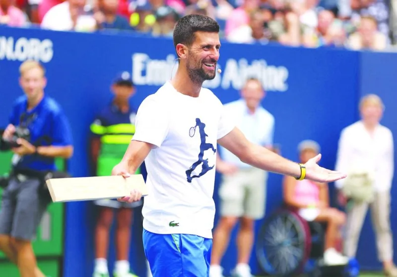 
Novak Djokovic of Serbia playing with a plank of wood as a racket during Arthur Ashe Kids’ Day at USTA Billie Jean King National Tennis Center in New York City. (AFP) 