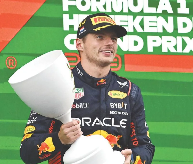 Red Bull Racing’s Dutch driver Max Verstappen celebrates with the trophy on the podium. (AFP)