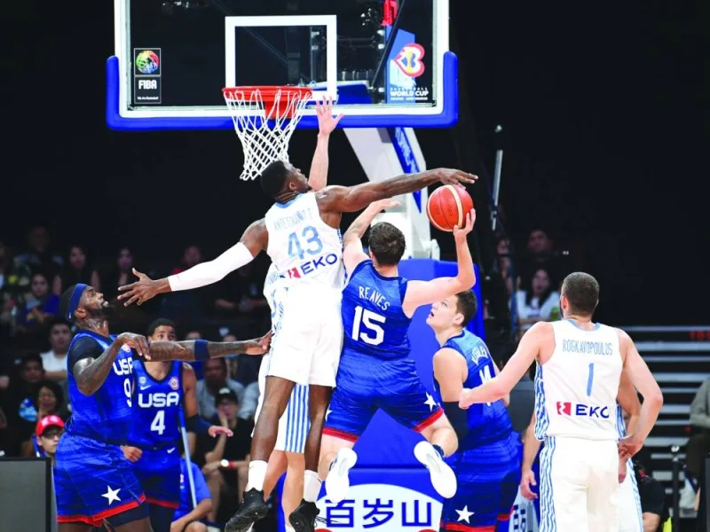 Austin Reaves (third right) of the US attempts to dunk the ball as Greece’s Thanasis Antetokounmpo (third left) defends during the FIBA Basketball World Cup, Group C match at the Mall of Asia Arena in Pasay city, suburban Manila on Monday. (AFP)