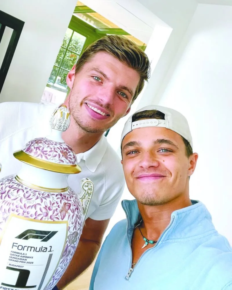 Red Bull’s Max Verstappen (left) receives a new Hungarian Grand Prix trophy that was accidentally broken by McLaren driver Lando Norris (right) during podium celebrations last month. Verstappen won the Hungarian Grand Prix in July and was given an ornate porcelain trophy that was broken by Norris by mistake. (@Max33Verstappen)