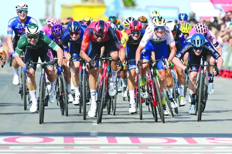 Stage winner Team Alpecin’s Australian rider Kaden Groves (second left) sprints to cross the finish line with Team Ineos’ Italian rider Filippo Ganna (centre) and Team TotalEnergies’ Belgian rider Dries Van Gestel (second right) during the fifth stage of the 2023 La Vuelta, on Wednesday. (AFP)