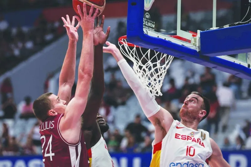 Latvia’s Andrejs Grazulis (left) shoots as Spain’s Victor Claver (right) and Usman Garuba try to block during the FIBA Basketball World Cup match in Jakarta on Friday. (AFP)