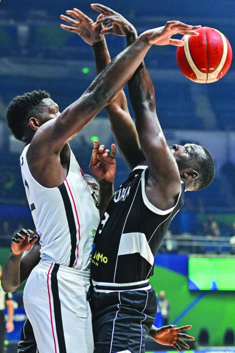 Angola’s Silvio De Sousa (left) and South Sudan’s Kuany Ngor Kuany vie for the ball during the FIBA Basketball World Cup Group M game at Smart Araneta Coliseum in Manila on Saturday. (AFP)